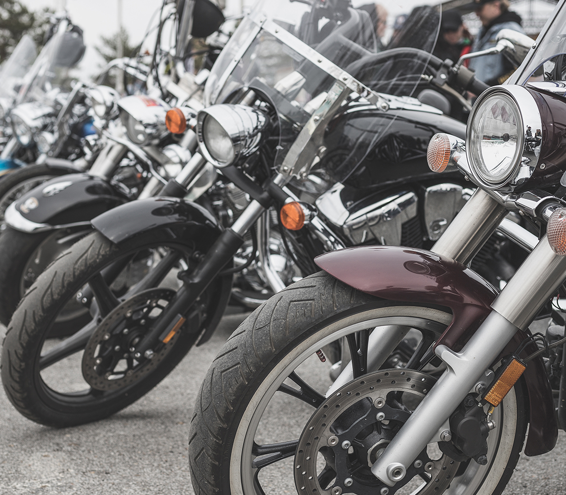Motorbikes lined up in a showroom, illustrating Readywire’s versatile ERP solutions for two-wheeler dealerships, in addition to a wide range of other automobile sectors.
